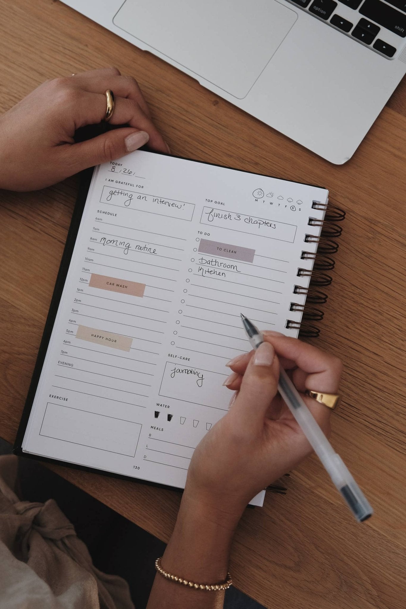 Person organizing a planner using Life Stickers for various activities